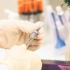 Waiving vaccine patents? Person holding a vaccine injection. Photo: Sam Moqadam (@itssammoqadam)