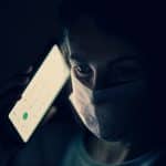 Infodemic, Person with a mask and a mobile phone. Photo: engin akyurt (@enginakyurt). Elcano Blog