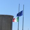 Salvini’s Italy between Greek tragedy and Portuguese fado. Flags of Italy and the European Union.