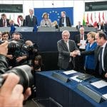 Angela Merkel and François Hollande greet Jean-Claude Juncker in the plenary chamber (European Parliament) on 7 October. Photo: European Parliament. Elcano Blog.