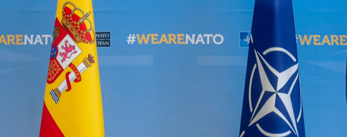 Flags of Spain and NATO with the hashtag #WeAreNATO (cropped image)
