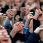 Manos entrelazadas elevadas al cielo de los feligreses durante la oración de los viernes en Teherán, capital de la República Islámica de Irán con el discurso del ayatolá Jamenei
