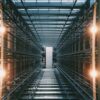 Computer servers and racks in a grey building that function as a data warehouse