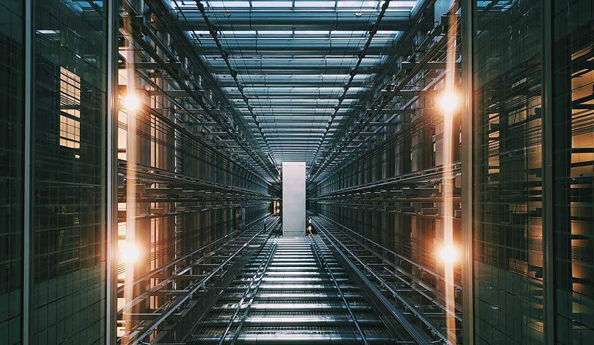 Computer servers and racks in a grey building that function as a data warehouse