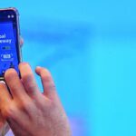 Hands holding a smartphone with the inscription “Global Gateway” (name of an EU initiative) on the screen