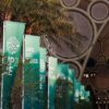 Palmeras con banderas verdes con el logo y el lema “Unite.Act.Deliver) en la vista general de la entrada a la COP28 en la Expo City Dubái en Emiratos Árabes Unidos (4 de diciembre de 2023)