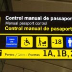 Close-up of an information panel at manual passport control at Barcelona-El Prat airport. The panel is in Catalan, Spanish and English. Immigration