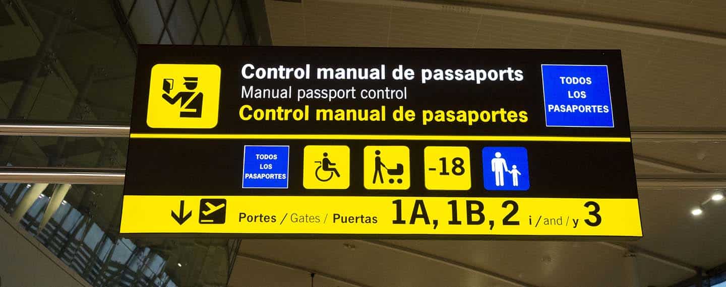 Close-up of an information panel at manual passport control at Barcelona-El Prat airport. The panel is in Catalan, Spanish and English. Immigration