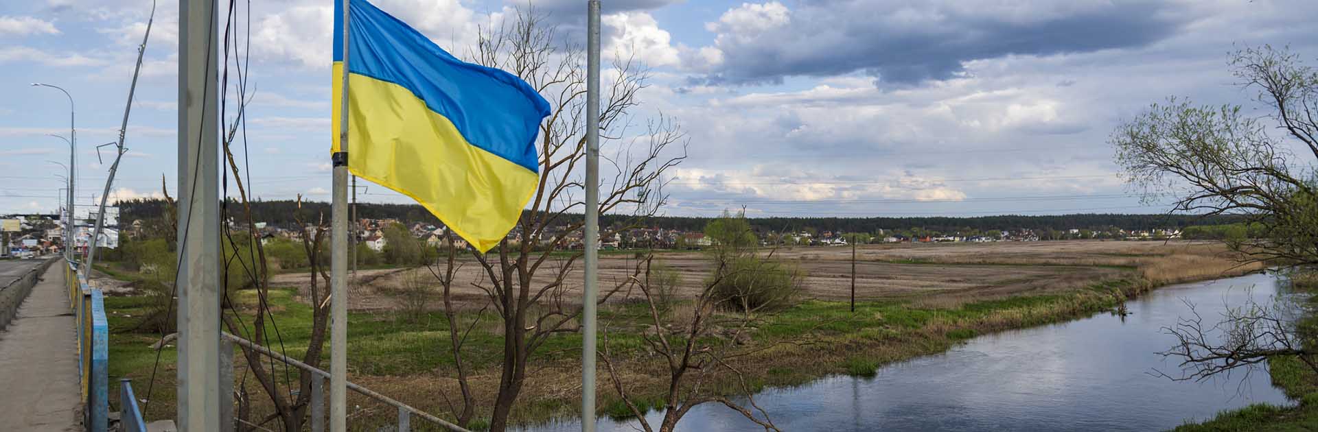 Flag of Ukraine waving on a bridge over the Irpin river, next to Hostomel, on the outskirts of Kyiv