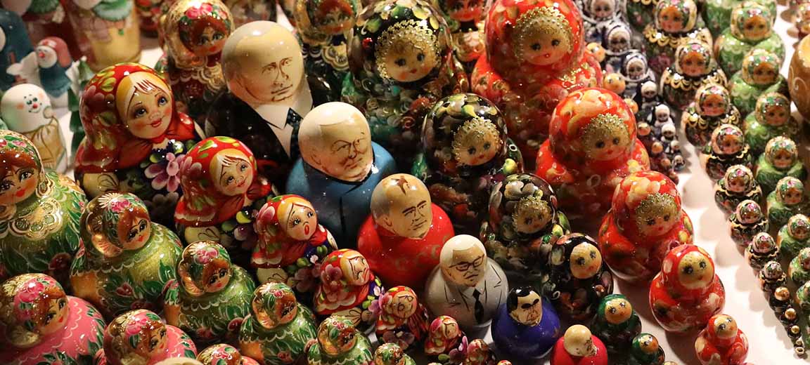 A set of matryoshka dolls displayed diagonally at a market in St. Petersburg, Russia. In the center the dolls with images of the leaders of Russia and the USSR