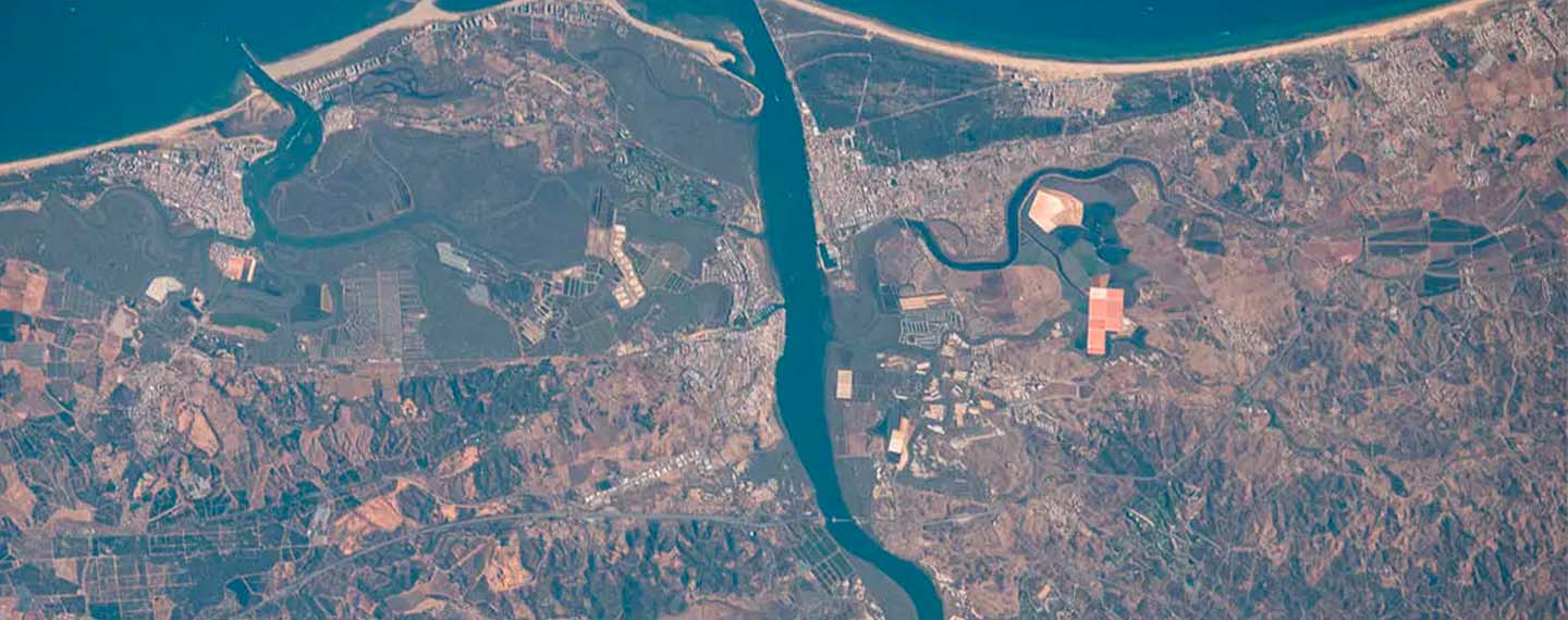 The Guadiana River flows into the Gulf of Cádiz in the Atlantic Ocean and is the border for the southern coastal portions of Portugal (right) and Spain (left).