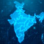 Digital map of India illuminated in blue tones, featuring a futuristic design that simulates a technological interface and data patterns in the background. India