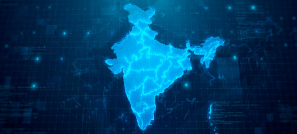 Digital map of India illuminated in blue tones, featuring a futuristic design that simulates a technological interface and data patterns in the background. India