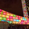 Nighttime projection on the United Nations Headquarters in New York City displaying the 17 colorful Sustainable Development Goals on the General Assembly building and a mosaic of world flags on the Secretariat tower, marking the UN’s 70th anniversary and promoting the 2030 Agenda for Sustainable Development. Private Capital Mobilisation