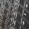 A dark digital panel at the Frankfurt Stock Exchange displays data from the German DAX stock index, with large, bright numbers showing share prices. tariff