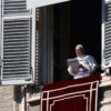 El Papa Francisco lee un discurso desde una ventana del Palacio Apostólico en el Vaticano durante el rezo del Ángelus, con una cortina roja decorativa colgando del alféizar. Vaticano