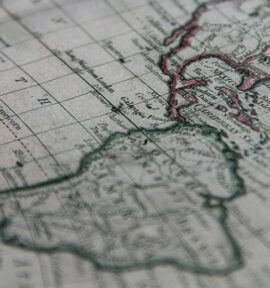 Detalle de un mapa histórico del continente americano, con tonos tierra y contorno en verde y rojo. Latinobarómetro
