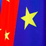 A row of European Union flags (blue with yellow stars) and Chinese flags (red with yellow stars) waving side by side during the 2020 EU–China summit.