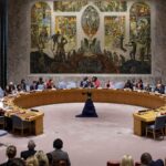 Members of the UN Security Council gathered around a circular table in the conference room with a mural in the background, to discuss the Women, Peace and Security Agenda (New York, 2022).