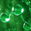Digital generated image of H2 hydrogen molecule made out of liquid on green background.